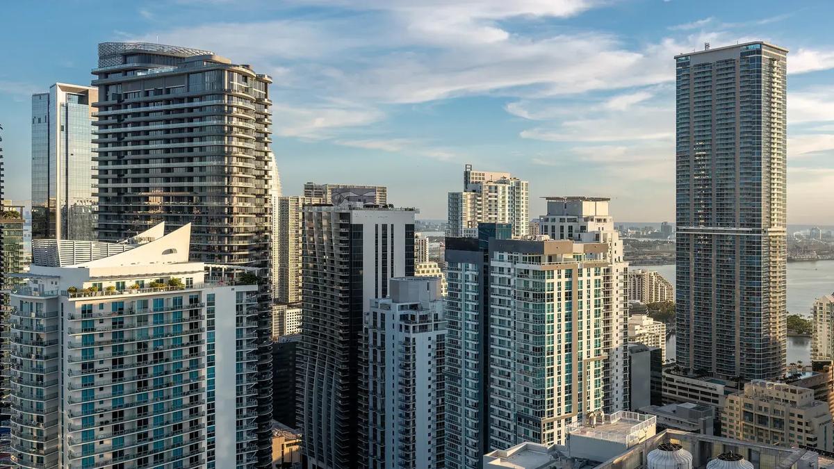 Brickell high-rise condo towers in Miami with Biscayne Bay in the background