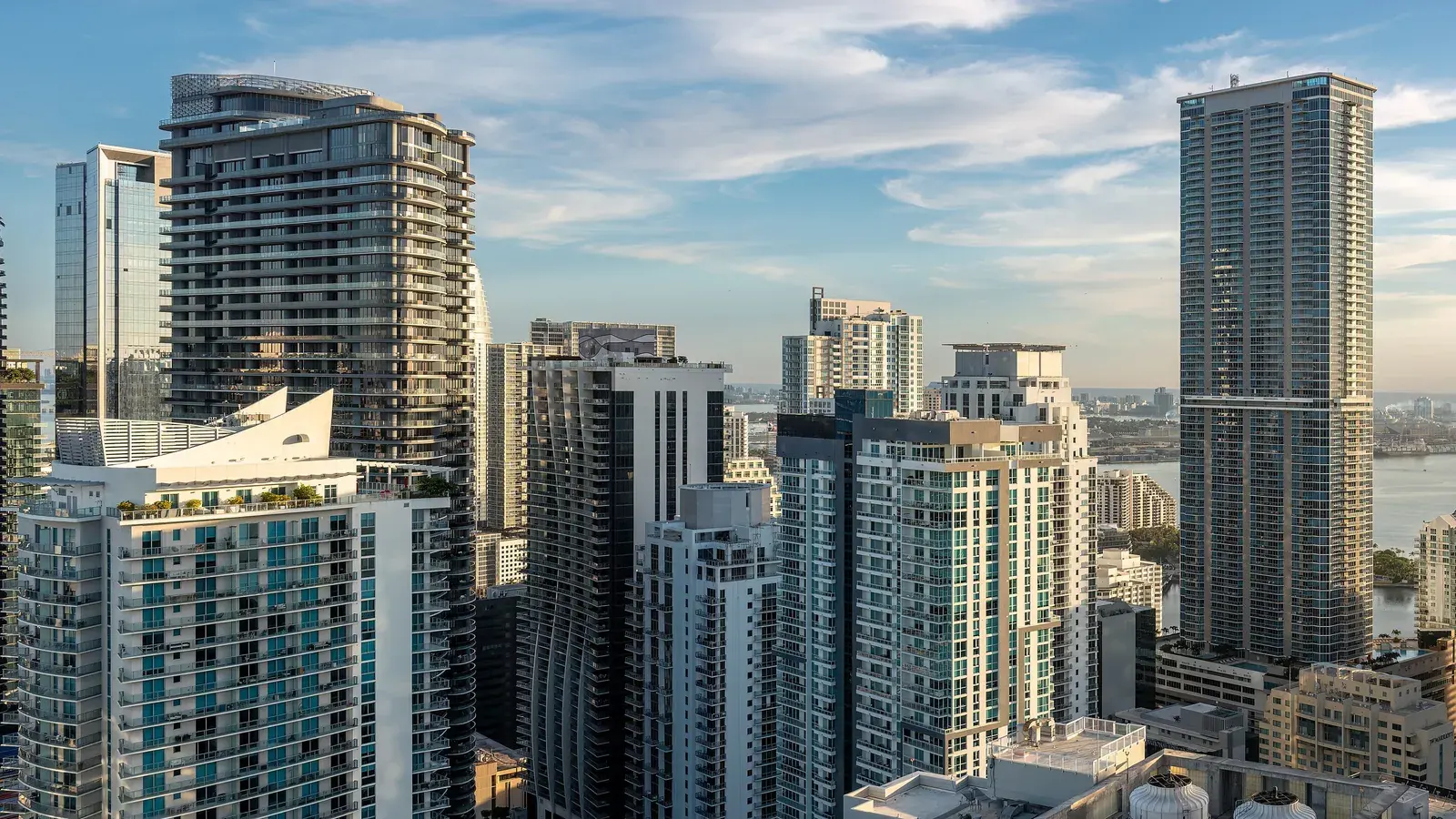 Brickell high-rise condo towers in Miami with Biscayne Bay in the background