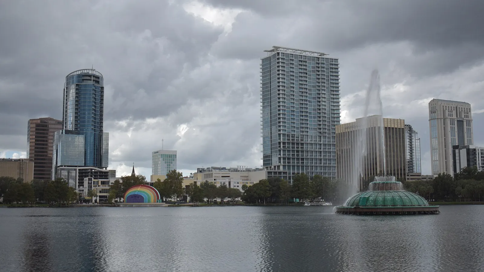 Downtown Orlando skyline and Lake Eola fountain under cloudy skies